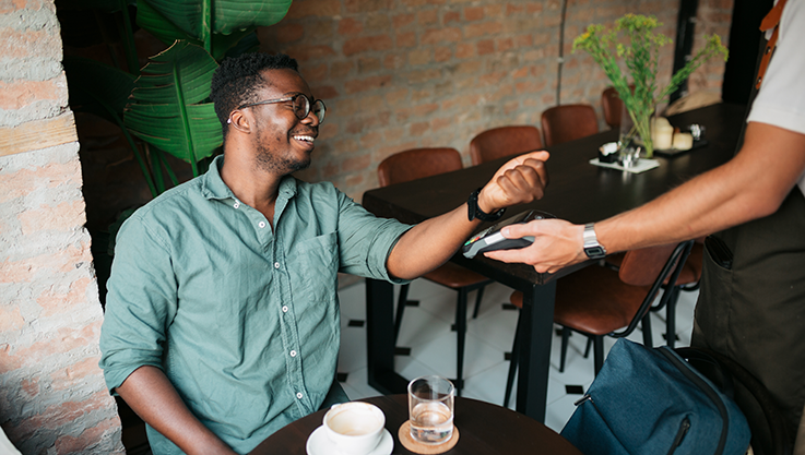 Man tapping watch to pay